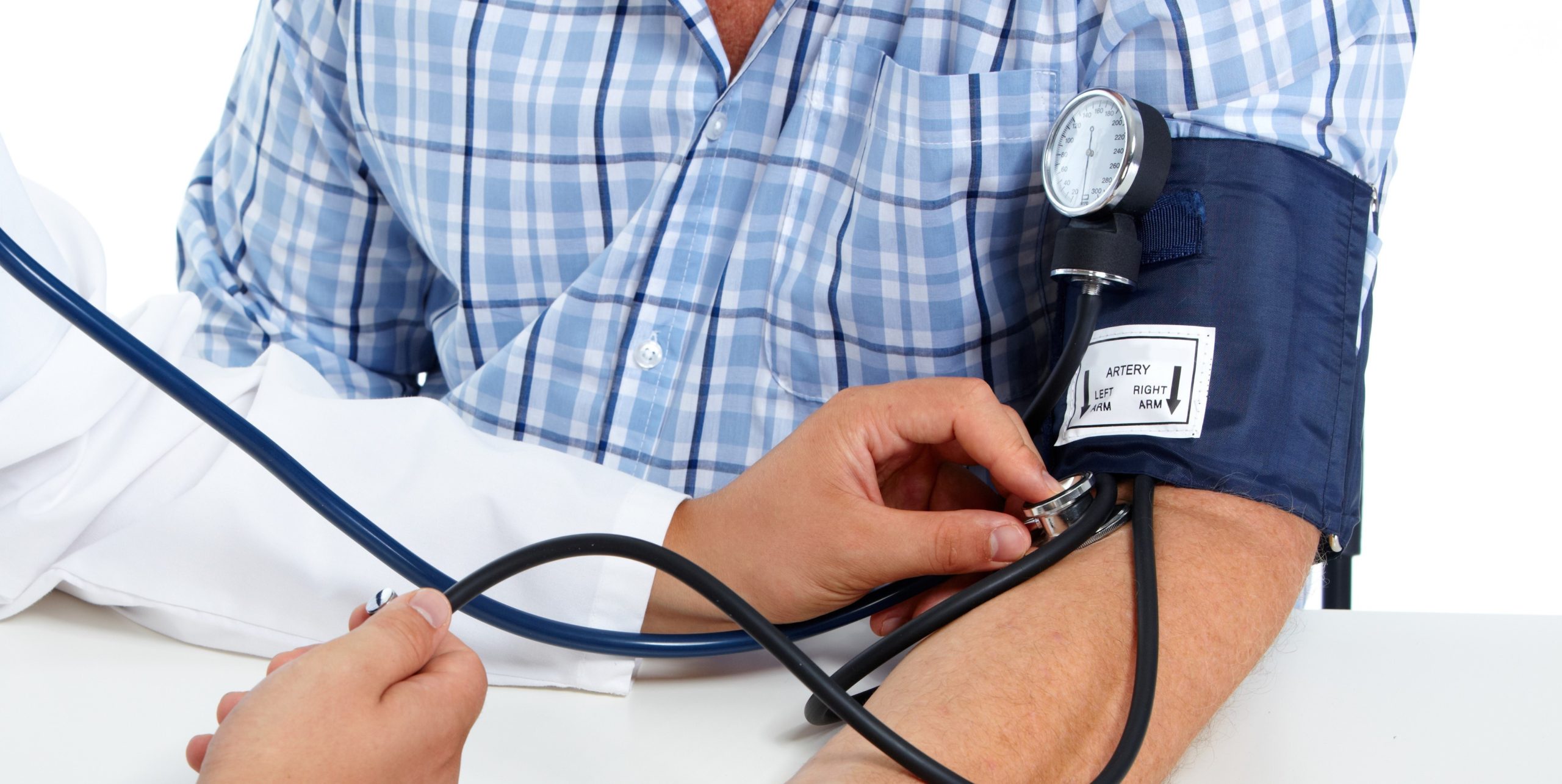 A man is taking his blood pressure with a stethoscope.