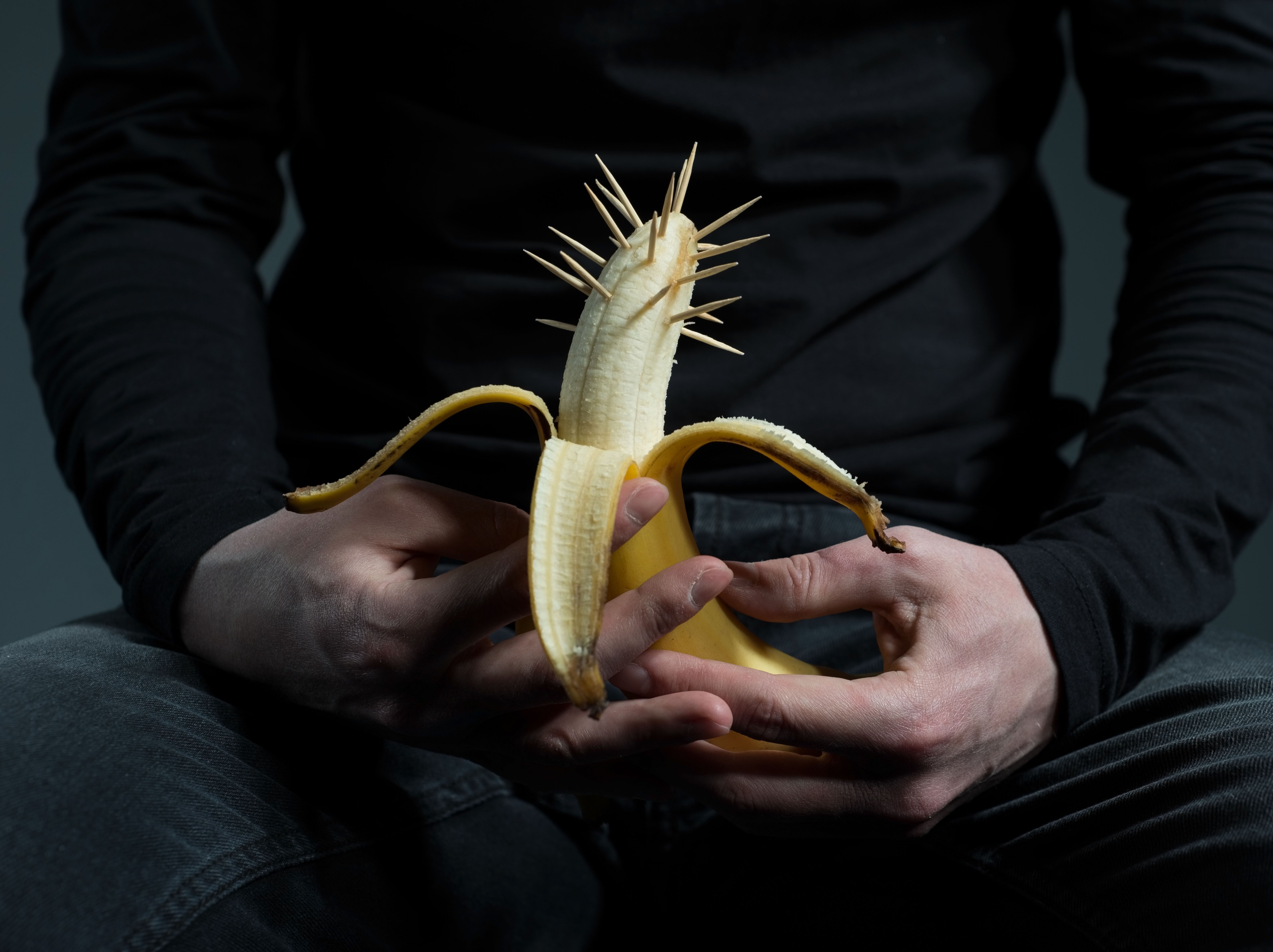 A person holding a banana in their hands.